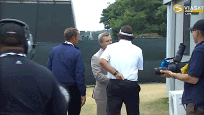 Tom Rinaldi pats Phil Mickelson on the ass.