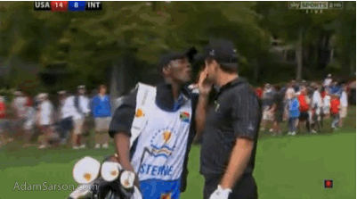 Richard Sterne's caddie helps his boss get something out of his eye.